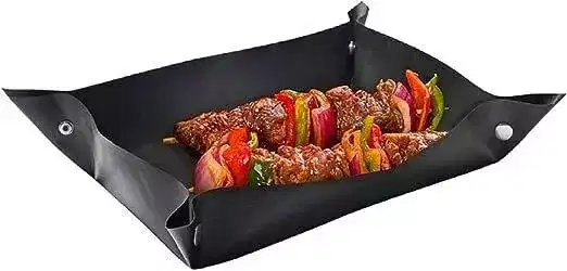 A black tray with skewers and vegetables in it.