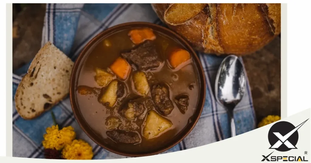 A hearty beef stew, perfect for foodies, featuring tenderized steak and served with crusty bread and carrots.