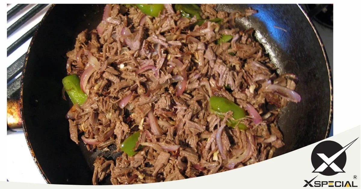 A frying pan with blade meat tenderizers and steak on it.